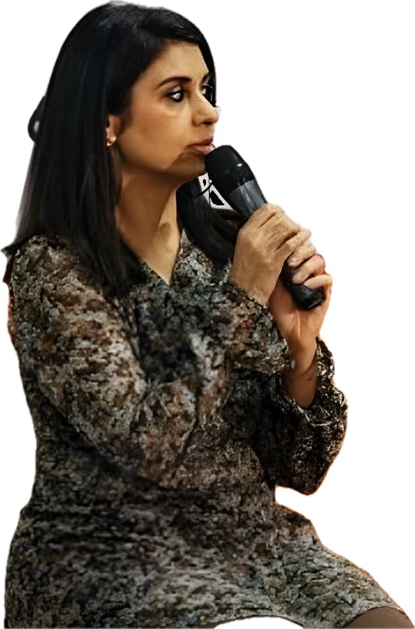 Ritu Java speaking into a microphone in Prague